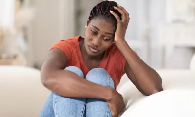 portrait depressed young black woman sitting couch home 116547 40376 1536x1024 1